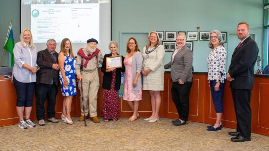 Rosemary Gosselin posing with members of Town Council in the Council Chambers