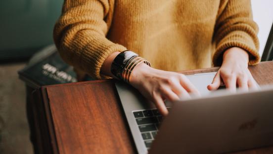 Woman typing on a laptop computer