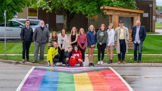 Students and Town staff posing at rainbow crosswalk in front of school