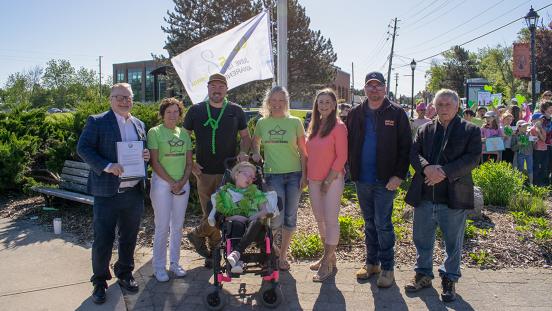 The Ladly Family and Members of Council standing in front of the CDKL5 Awareness Flag