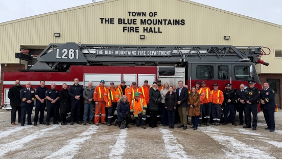Town staff and first responders in front of a fire truck alongside members of Council and MPP Saunderson