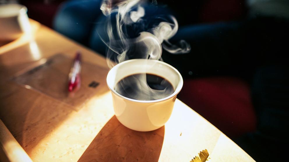 Steaming coffee mug on table