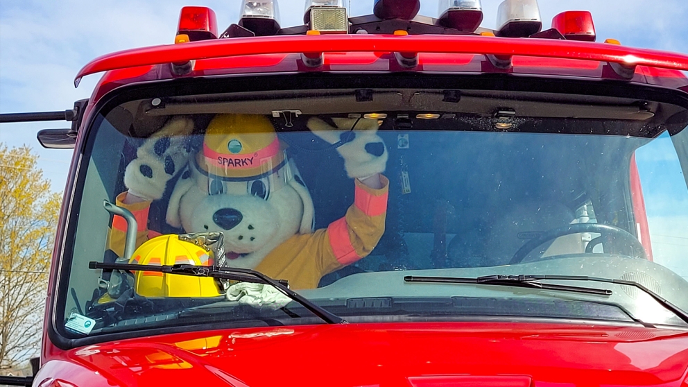 Sparky the Fire Dog sitting in a fire truck