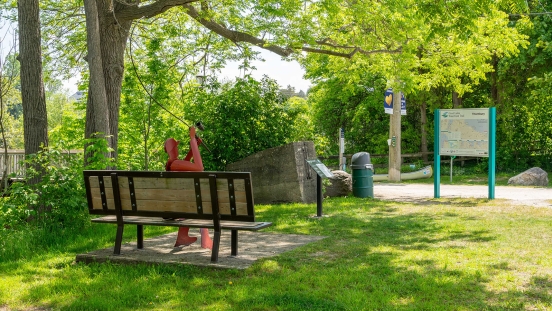 Signage and bench with sculpture in Bruce Street Parkette