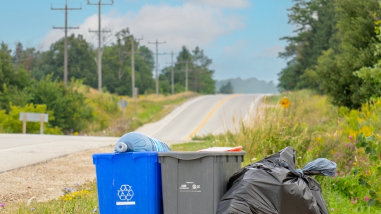 Recycling bins and garbage on the side of the road