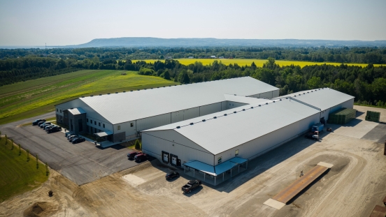 Drone shot of industrial buildings with escarpment in background