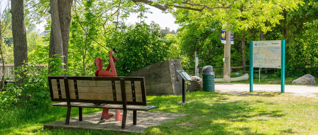 Signage and bench with sculpture in Bruce Street Parkette