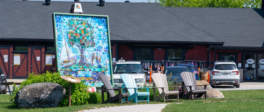 Muskoka chairs in front of Canada 150 mural