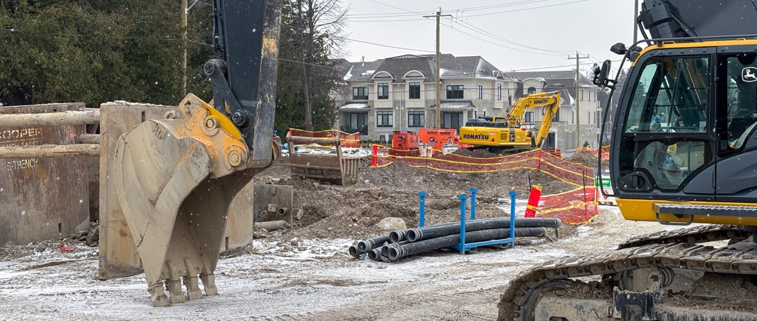 Excavator parked in front of site on Bay Street East