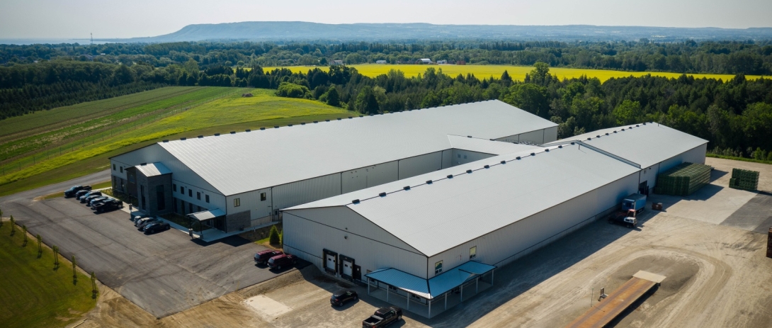 Drone shot of industrial buildings with escarpment in background