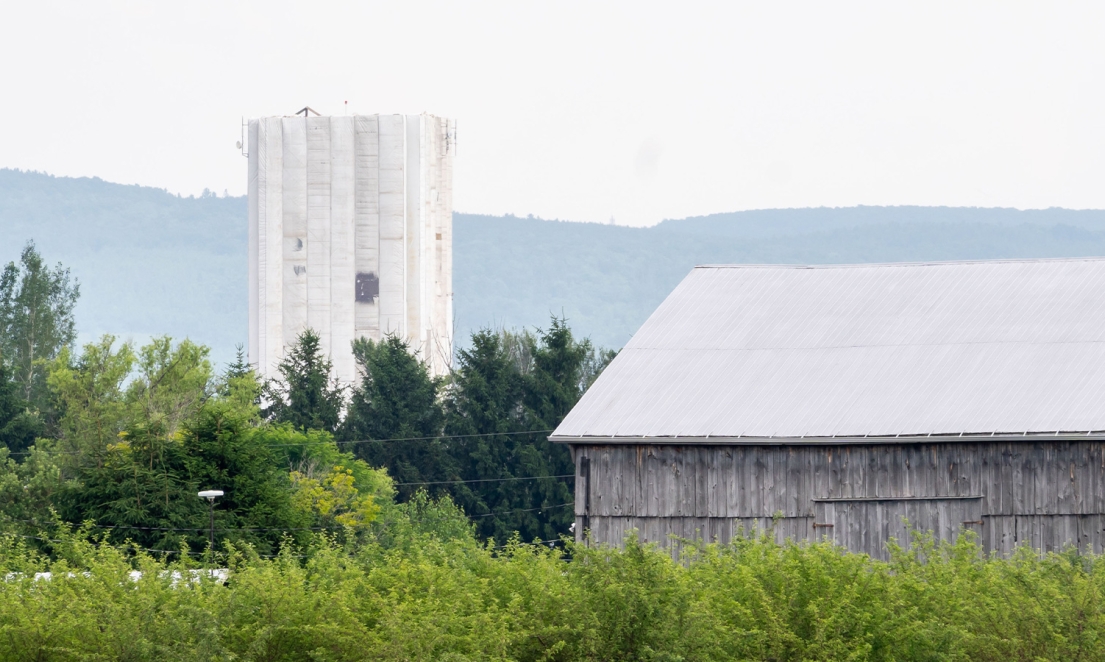 Scaffolding around water tower covered in plastic shrouding