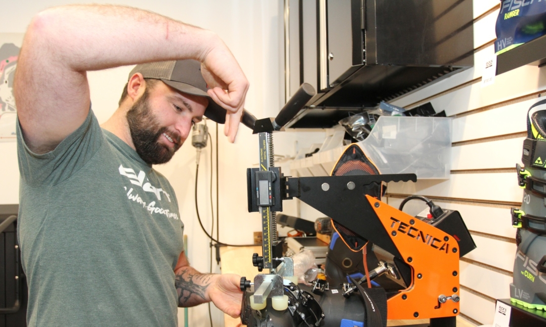 Worker performing custom fitting on ski boot