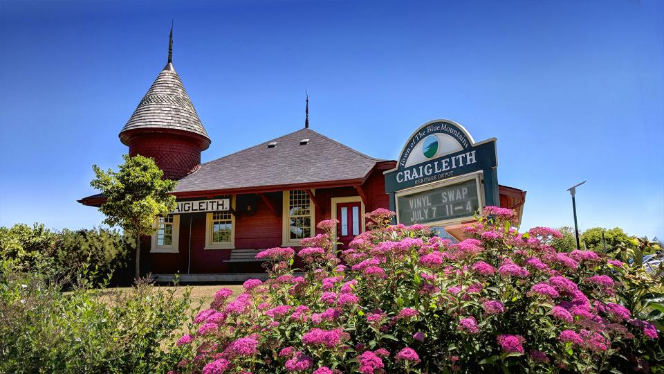 Exterior of Craigleith Depot on a summer day with flowers in foreground