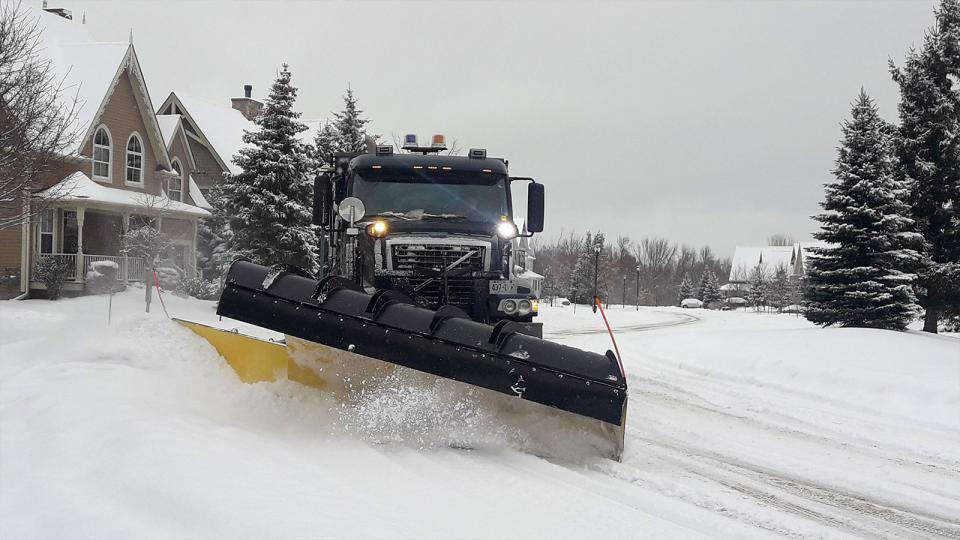 Snowplow clearing residential street