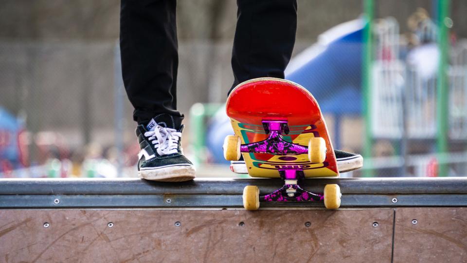 Skateboarder getting ready to drop in to mini ramp