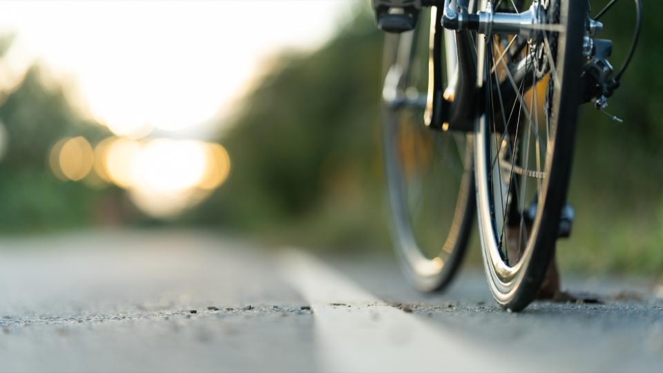 Close up of the front tire of a bicycle on a road