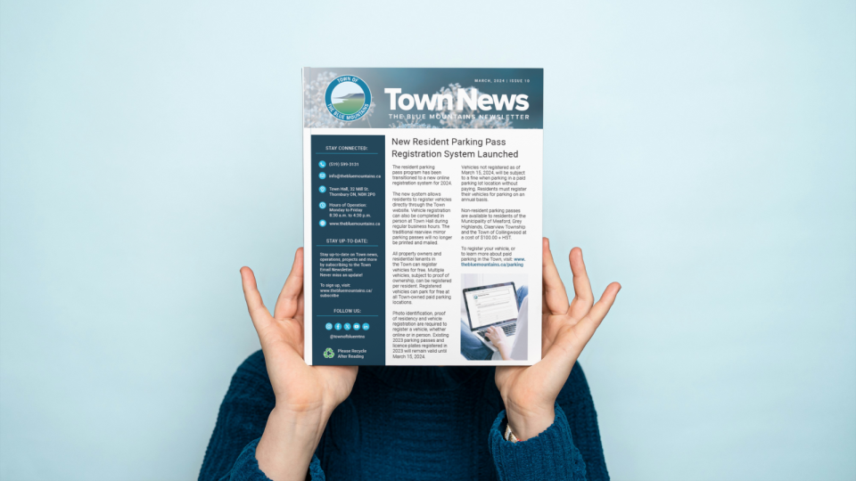 Person holding the town Newsletter