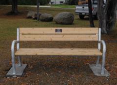 Galvanized steel memorial bench at a park